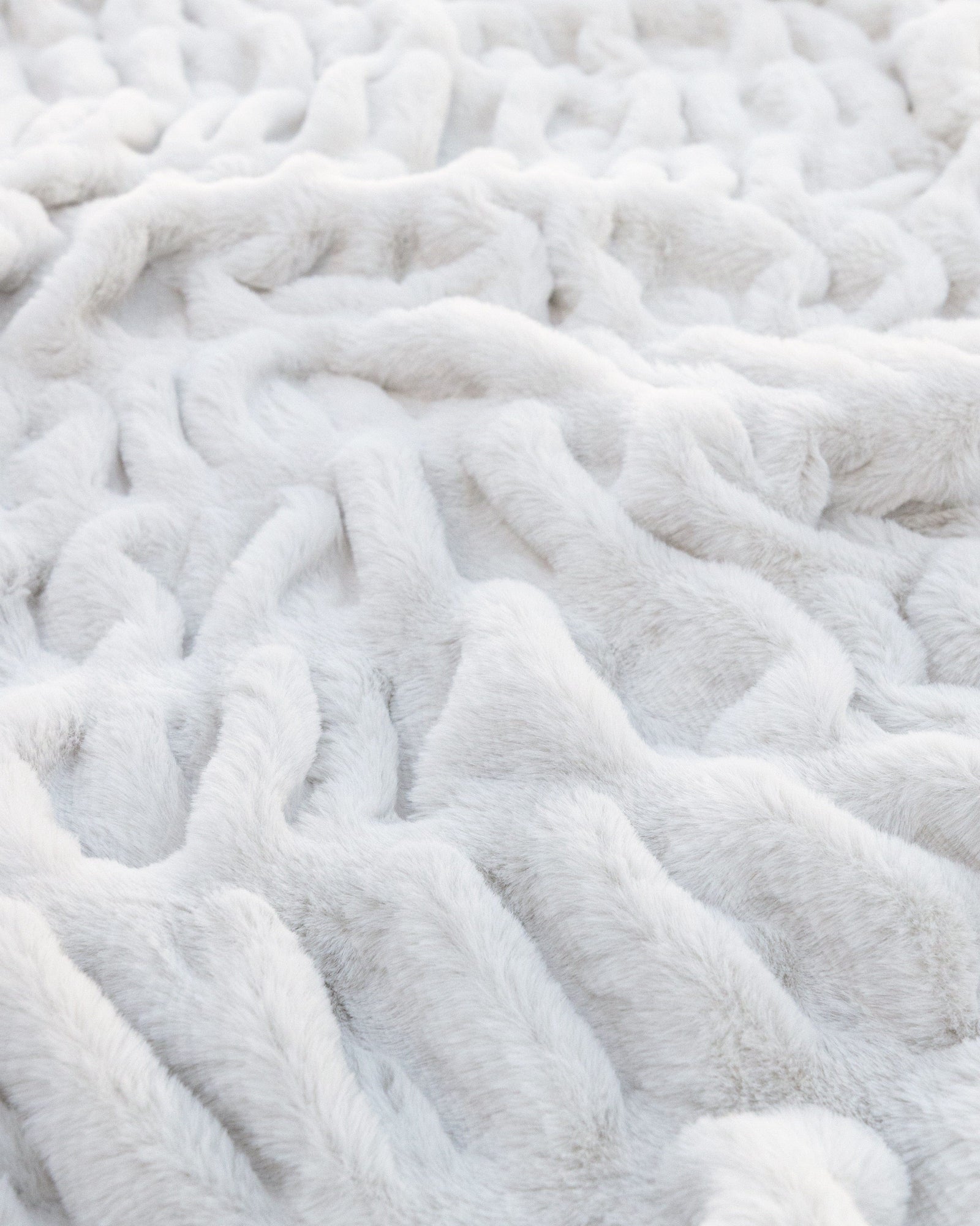 Close view of cream ruched faux fur with the pile standing full