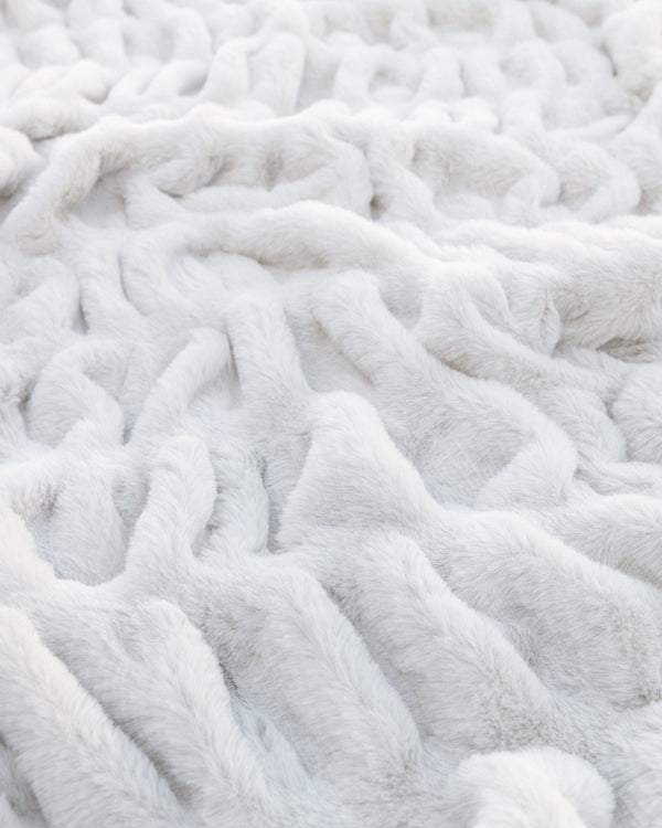 Close view of cream ruched faux fur with the pile standing full