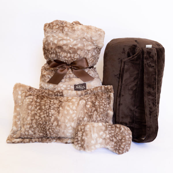A fawn print blanket, matching pillow and espresso carry bag tied with a ribbon as a gift set