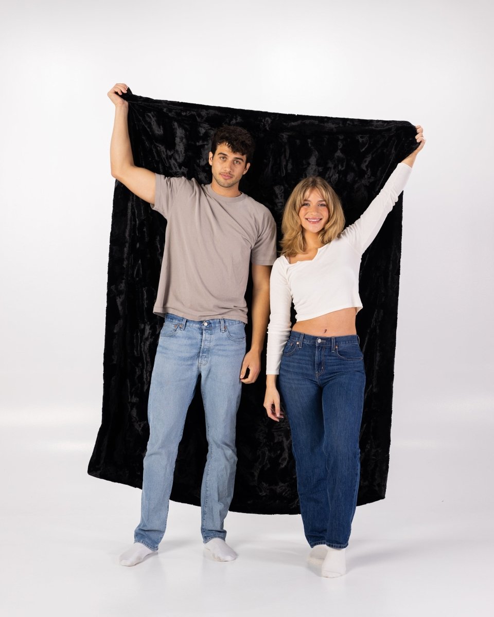Black Bella Throw soft faux fur oversized blanket held by couple