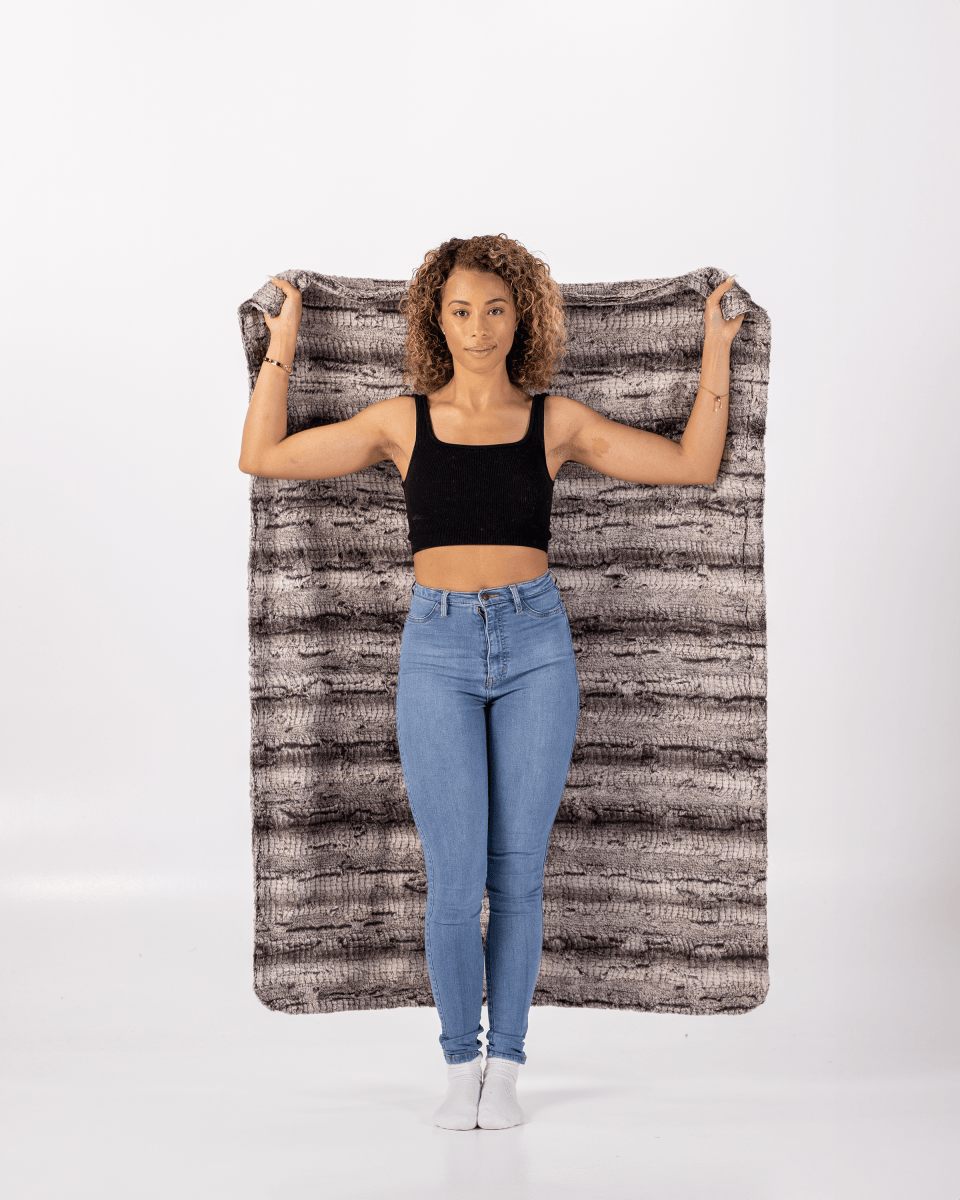 Black Birch Throw luxurious super soft faux fur everyday blanket held by a woman