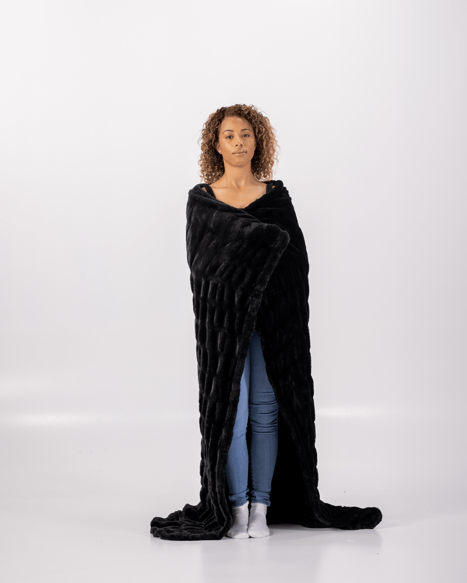 Caviar Black Cloud Throw ultra soft luxury faux fur weighted everyday blanket wrapped around cozy woman