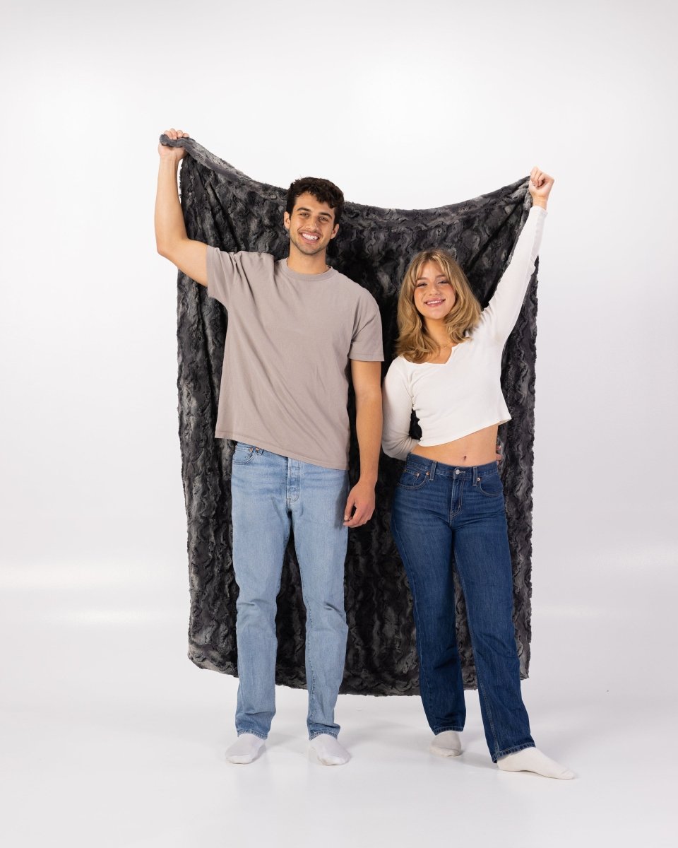 Charcoal Dark Gray Throw soft faux fur blanket held by couple
