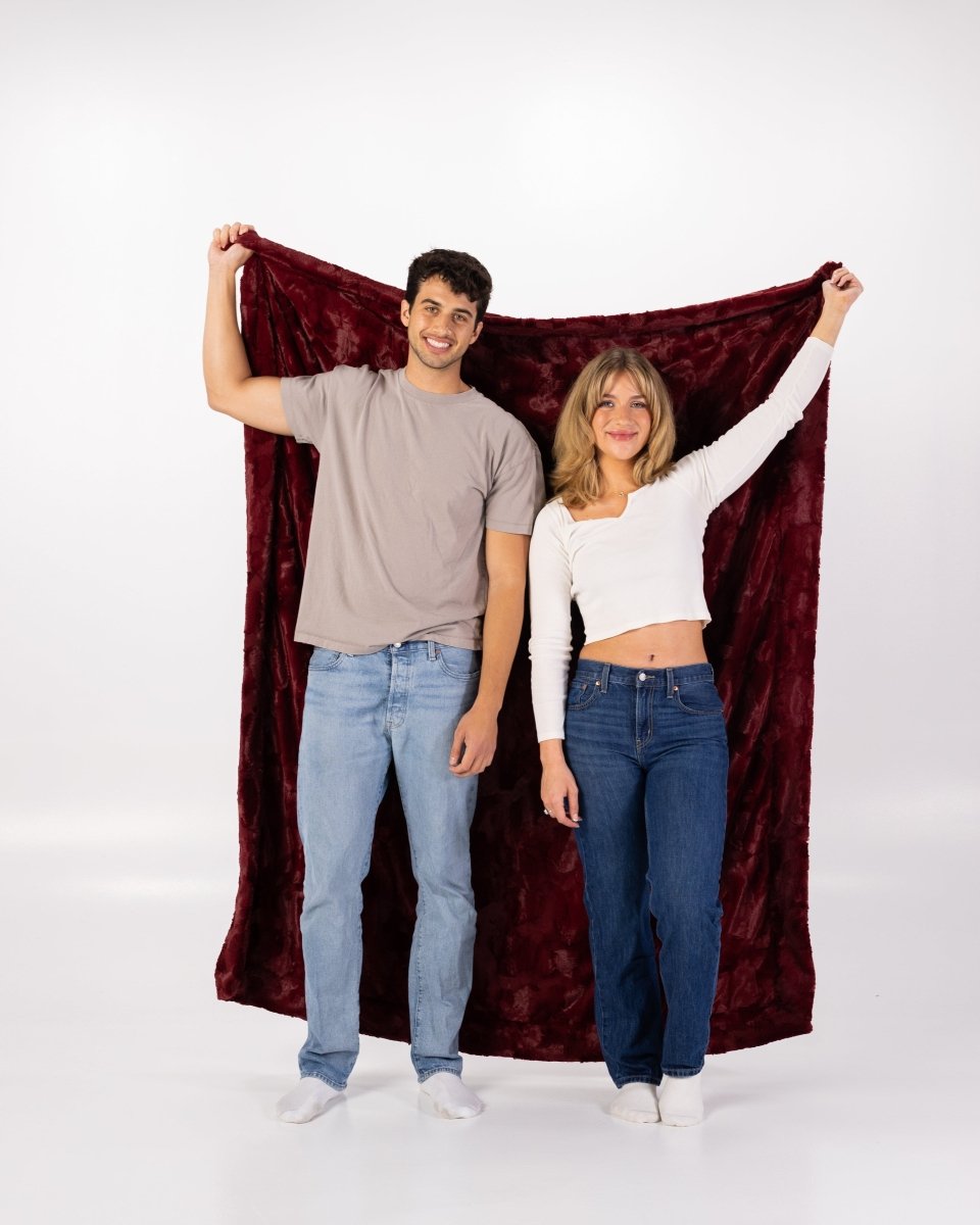 Crimson Red Throw soft faux fur oversized blanket held up by a couple