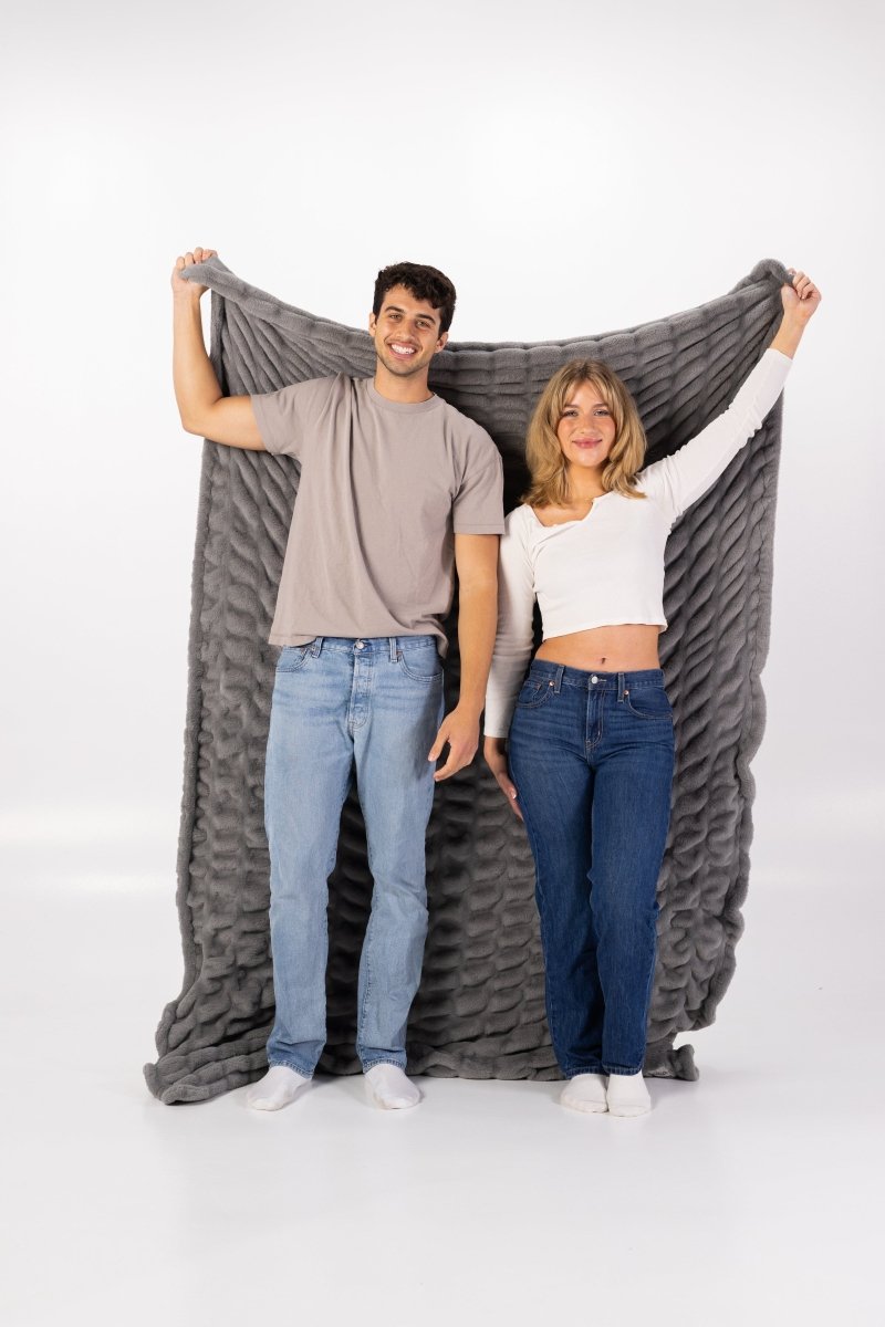 Graphite Gray Cloud Throw ultra soft luxury faux fur weighted oversized blanket held by couple