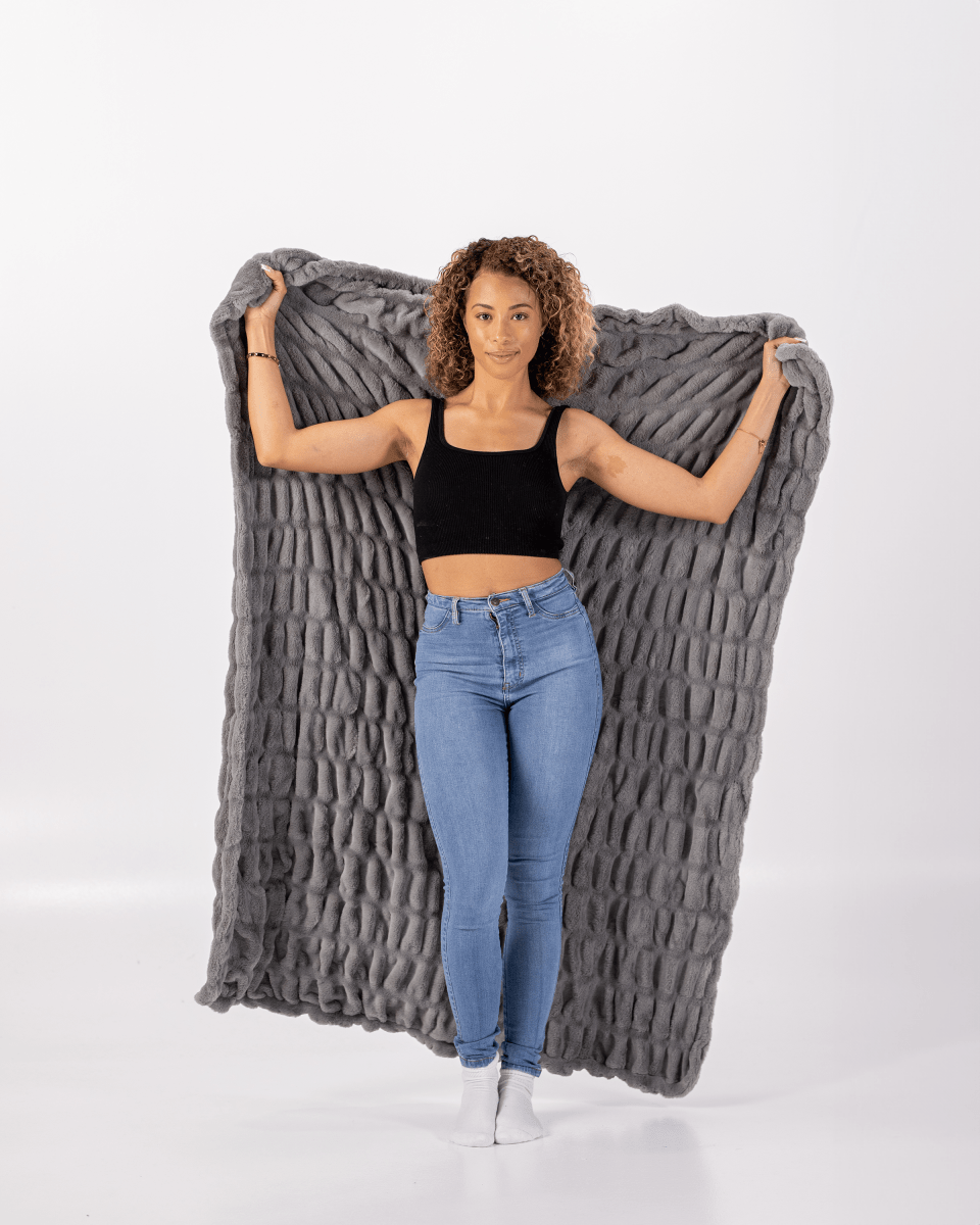 Graphite Gray Cloud Throw ultra soft luxury faux fur weighted everyday blanket held by woman