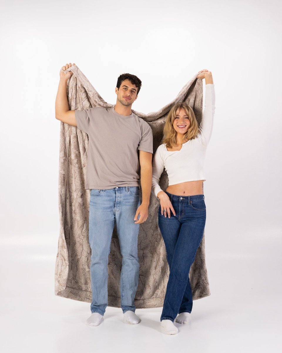 Quartz Tan Throw soft faux fur oversized blanket held by couple