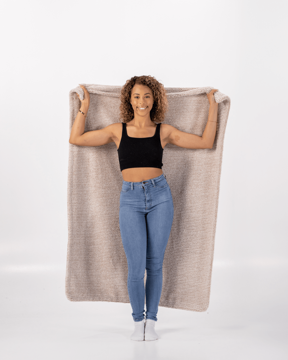 Quartz Tan Weave Throw soft woven everyday blanket held up by woman
