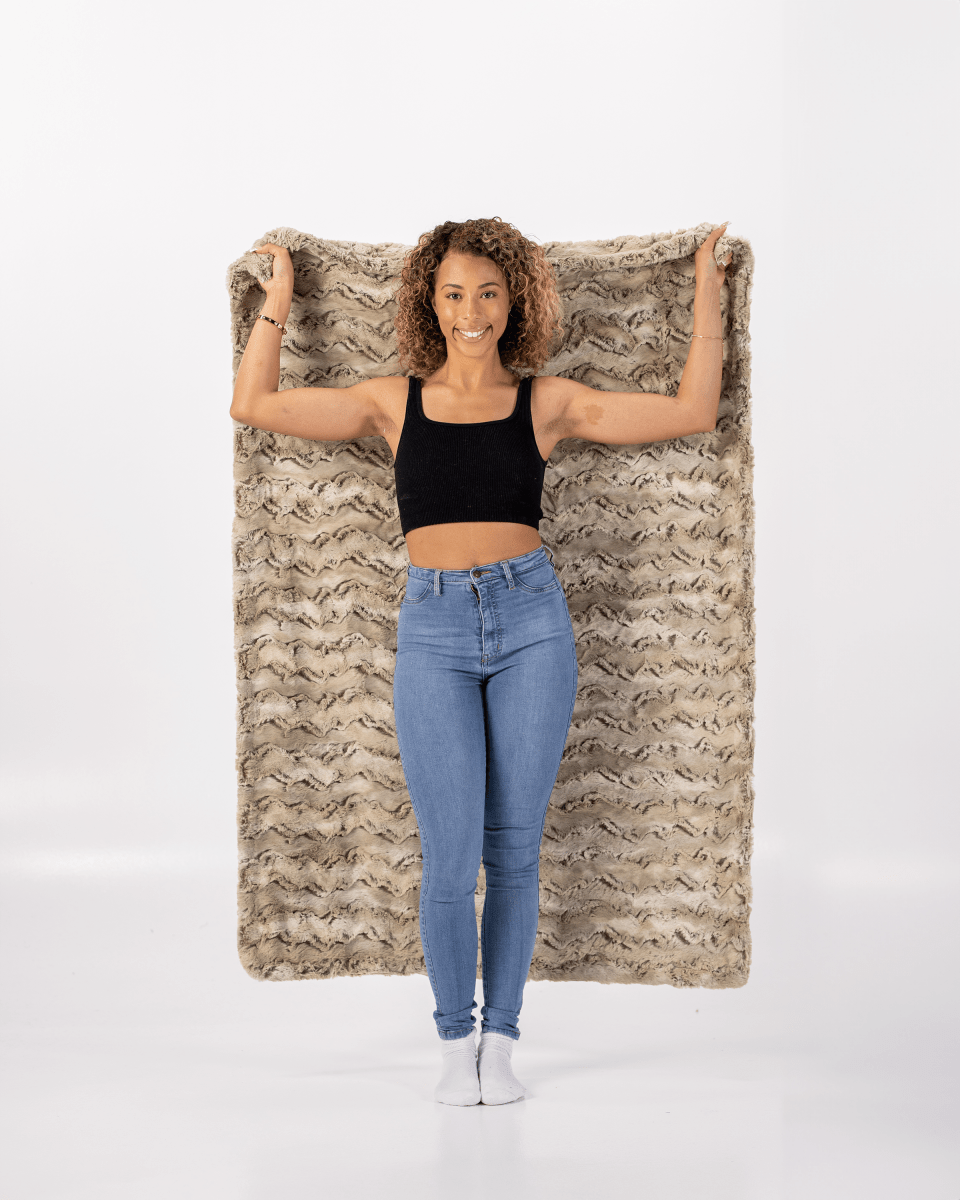 Sandshell Tan Brown Throw soft faux fur everyday blanket held by woman