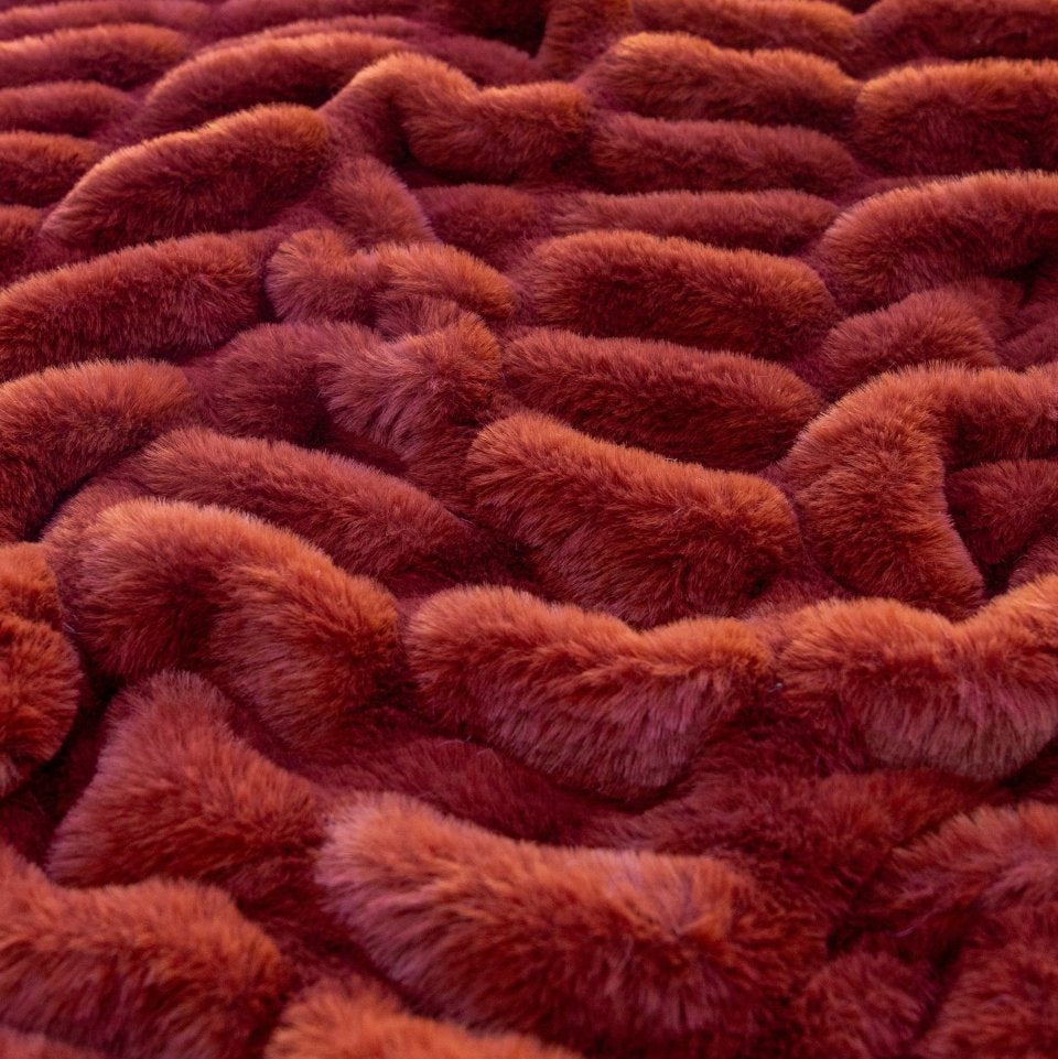 Sienna Cloud Throw, a dark orange color, draped to show rippling soft texture