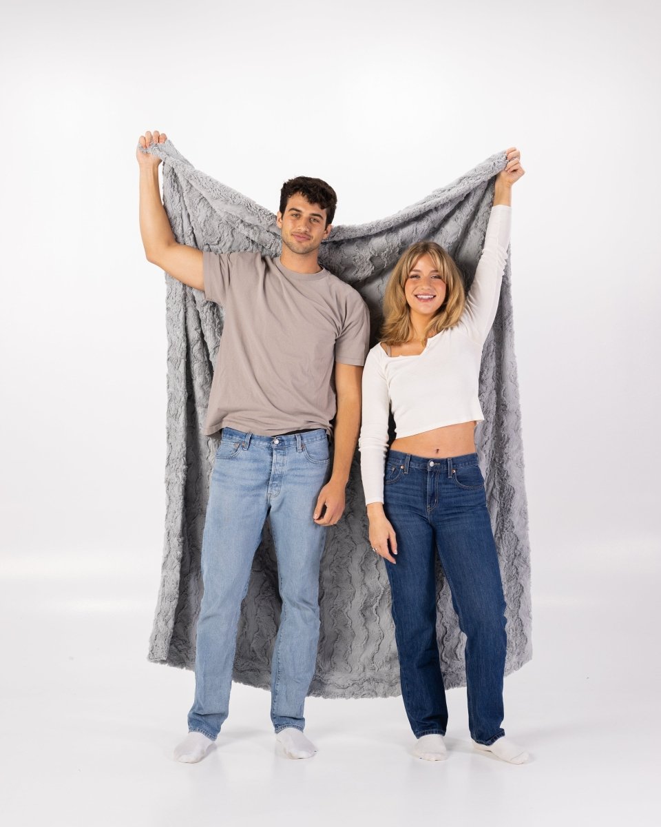 Silver Gray Throw held by couple, oversized blanket.