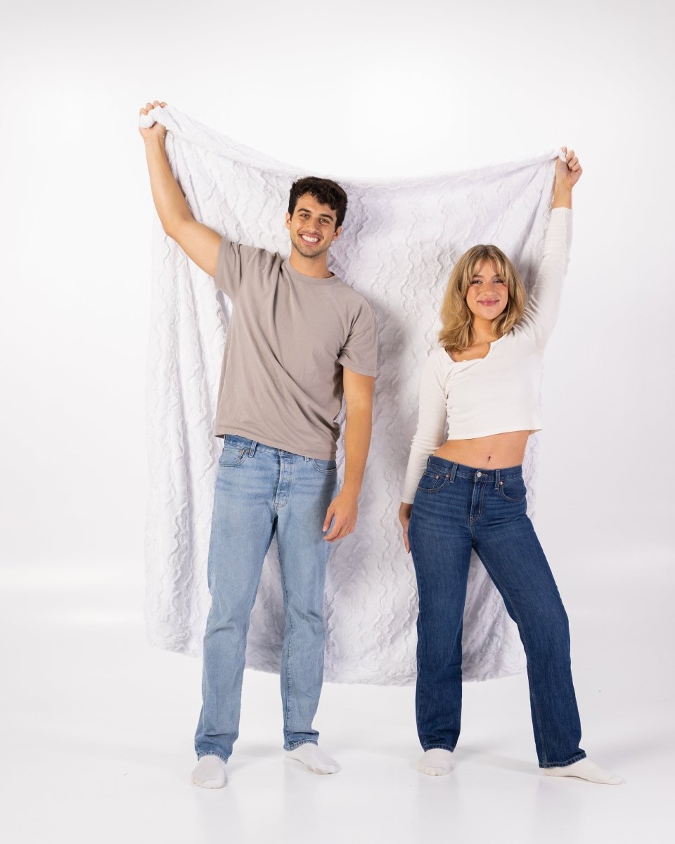 White Bella Throw soft faux fur oversized blanket held by couple