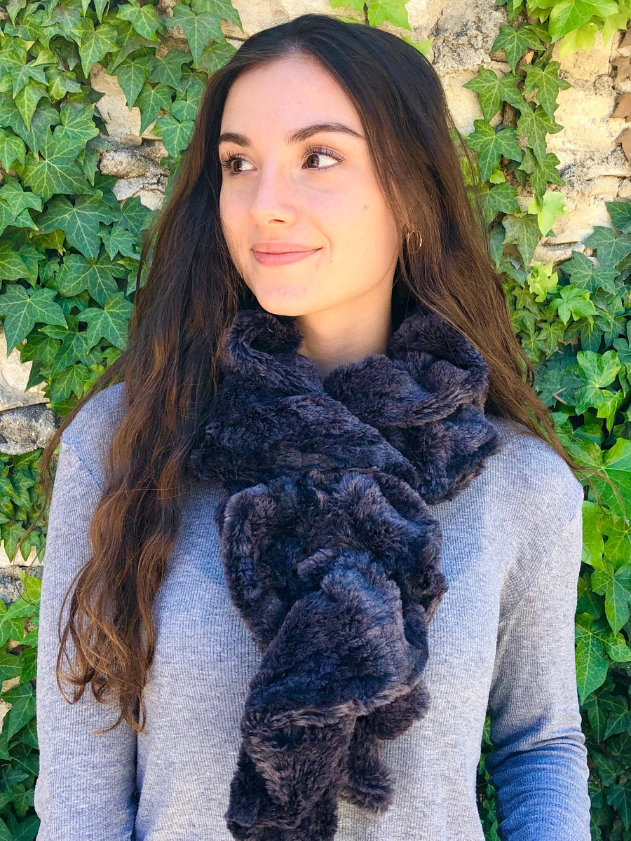 women keeping her Neck Warm with a scarf-like dark blue colored Neck Warmer which is the called the Ash Neck Warmer