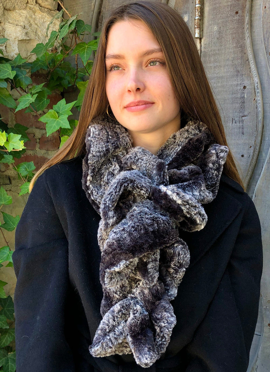 women keeping her Neck Warm with a scarf-like part black and part white colored Neck Warmer which is the called the Black Birch Neck Warmer