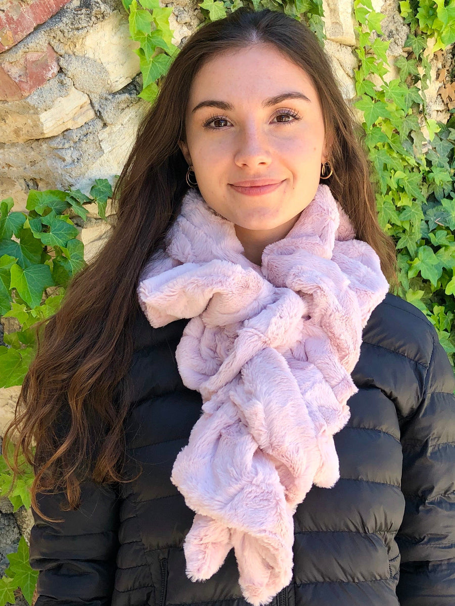 women keeping her Neck Warm with a scarf-like light pink colored Neck Warmer which is the called the Blush Neck Warmer