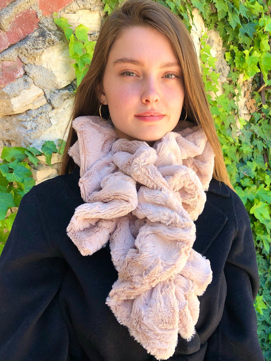 women keeping her Neck Warm with a scarf-like light pink-beige colored Neck Warmer which is the called the Camel Neck Warmer
