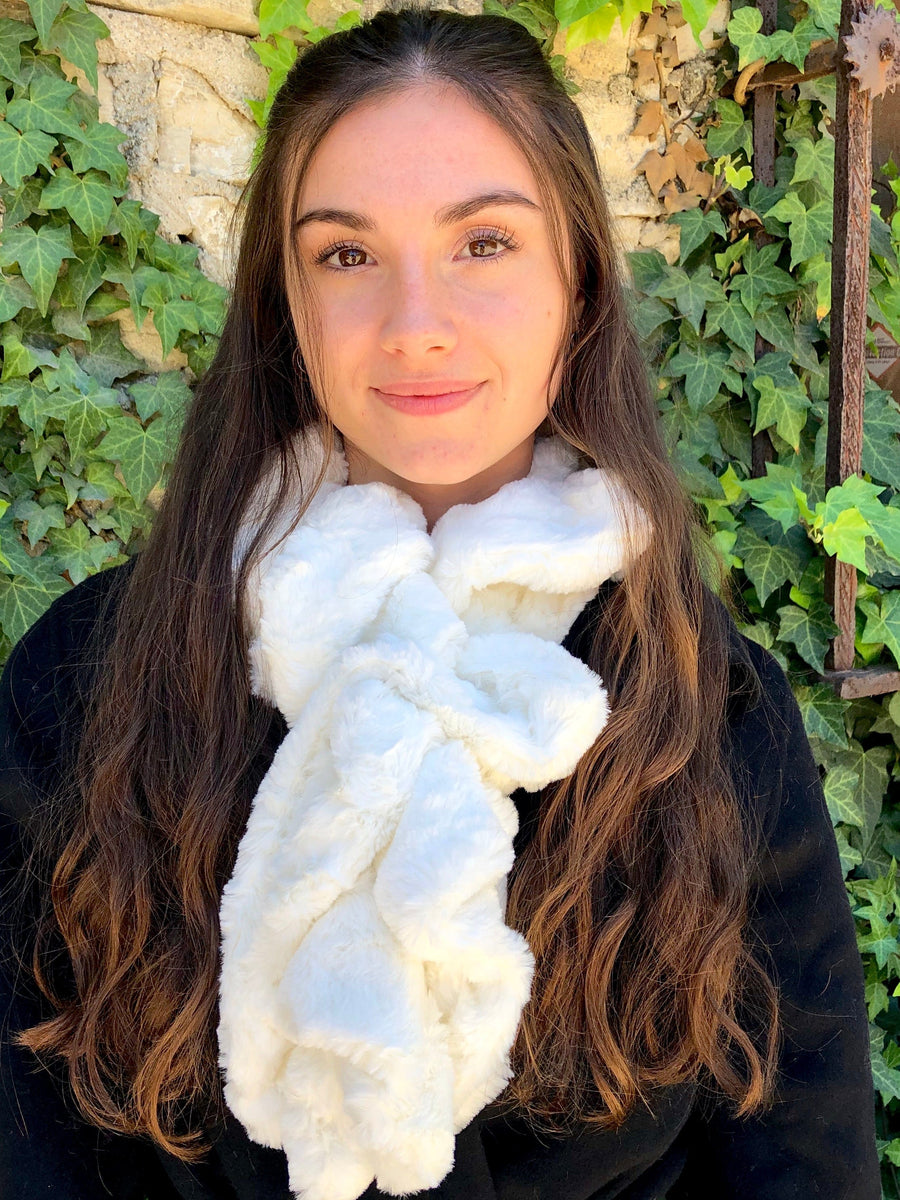 women keeping her Neck Warm with a scarf-like white with a slight touch of yellow colored Neck Warmer which is the called the Ivory Neck Warmer