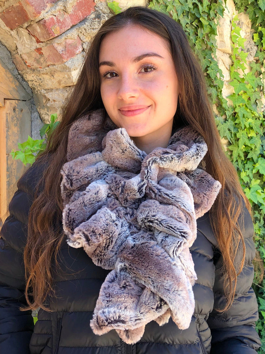 women keeping her Neck Warm with a scarf-like part dark brown-red and part gray colored Neck Warmer which is the called the Mountain Fox Neck Warmer