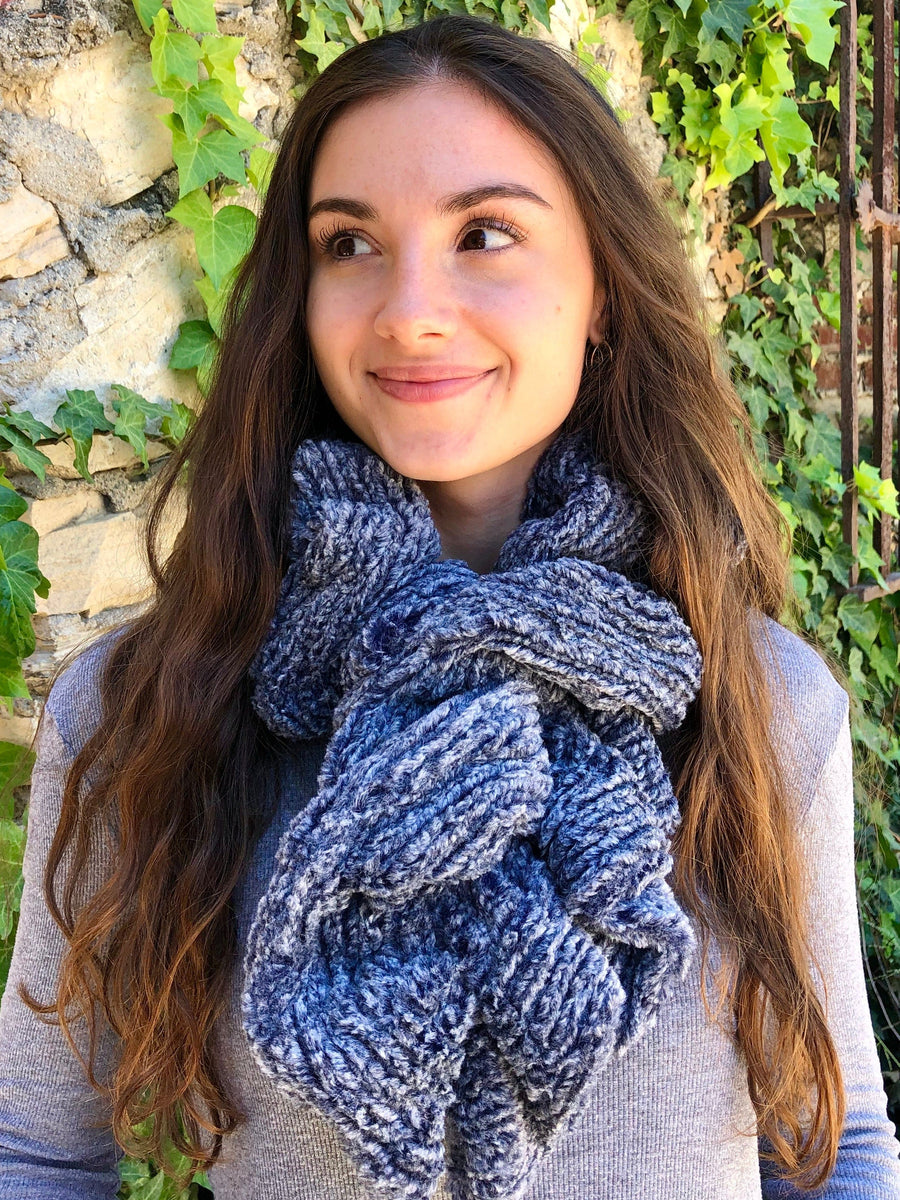 women keeping her Neck Warm with a scarf-like part navy-blue and part white colored stripe textured Neck Warmer which is the called the Mountain Fox Neck Warmer