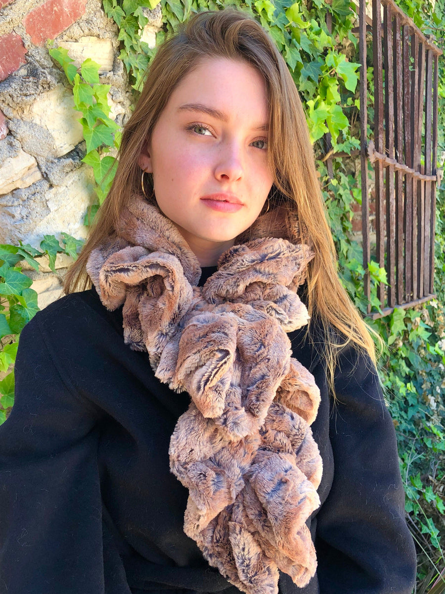 women keeping her Neck Warm with a scarf-like light brown-red with small streaks of black colored Neck Warmer which is the called the Red Wolf Neck Warmer