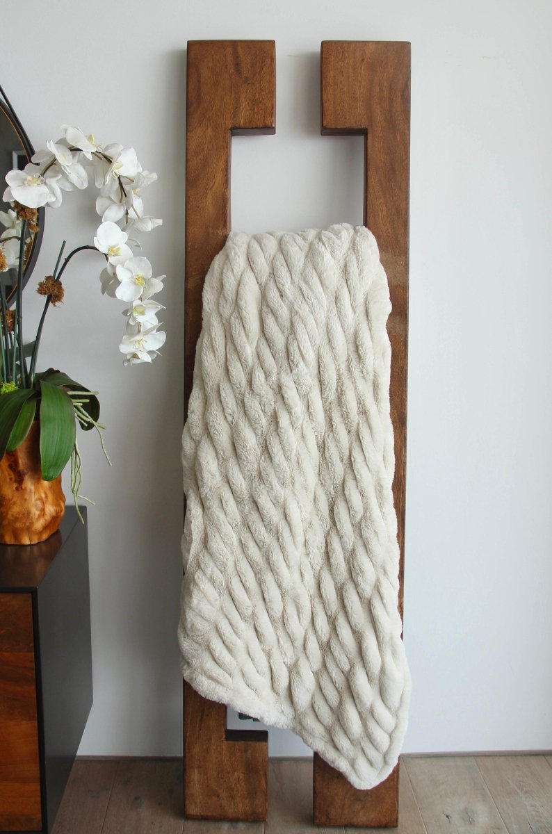 Dune Cream Cloud Throw ultra soft luxury faux fur weighted blanket draped in living room.