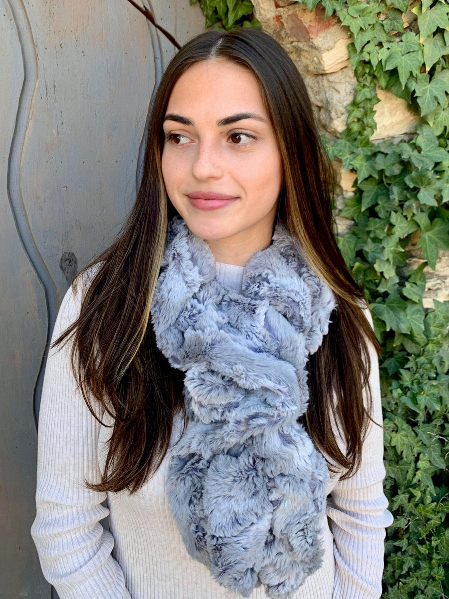 women keeping her Neck Warm with a scarf-like light blue with a hint of gray Neck Warmer which is the called the Silver Lining Neck Warmer