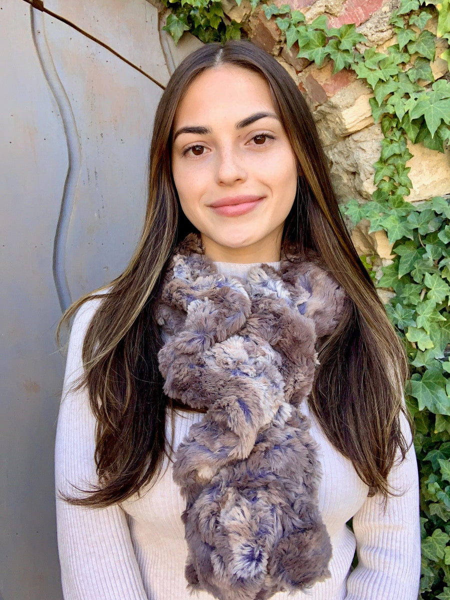 women keeping her Neck Warm with a scarf-like part brown and part light-brown with small streaks of purple colored Neck Warmer which is the called the Driftwood Neck Warmer