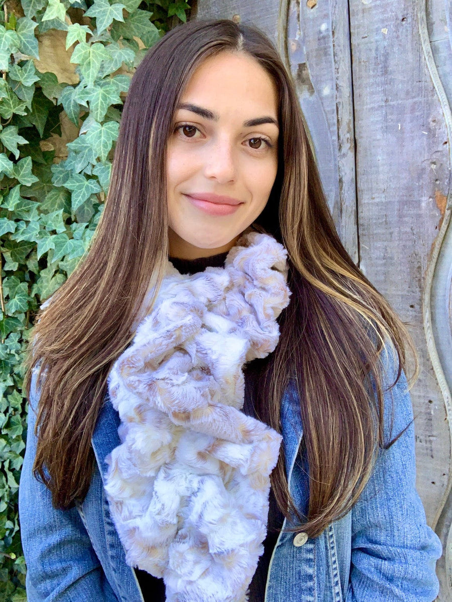 women keeping her Neck Warm with a scarf-like part white, part light-purple and part light-brown colored Neck Warmer which is the called the Snowy Owl Neck Warmer