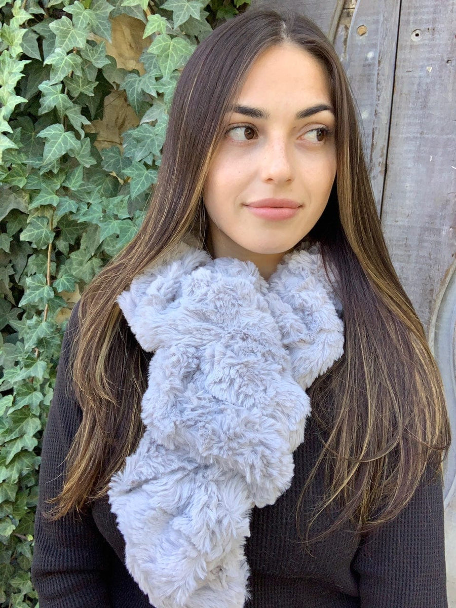 women keeping her Neck Warm with a scarf-like fluffy silver colored Neck Warmer which is the called the Silver Neck Warmer