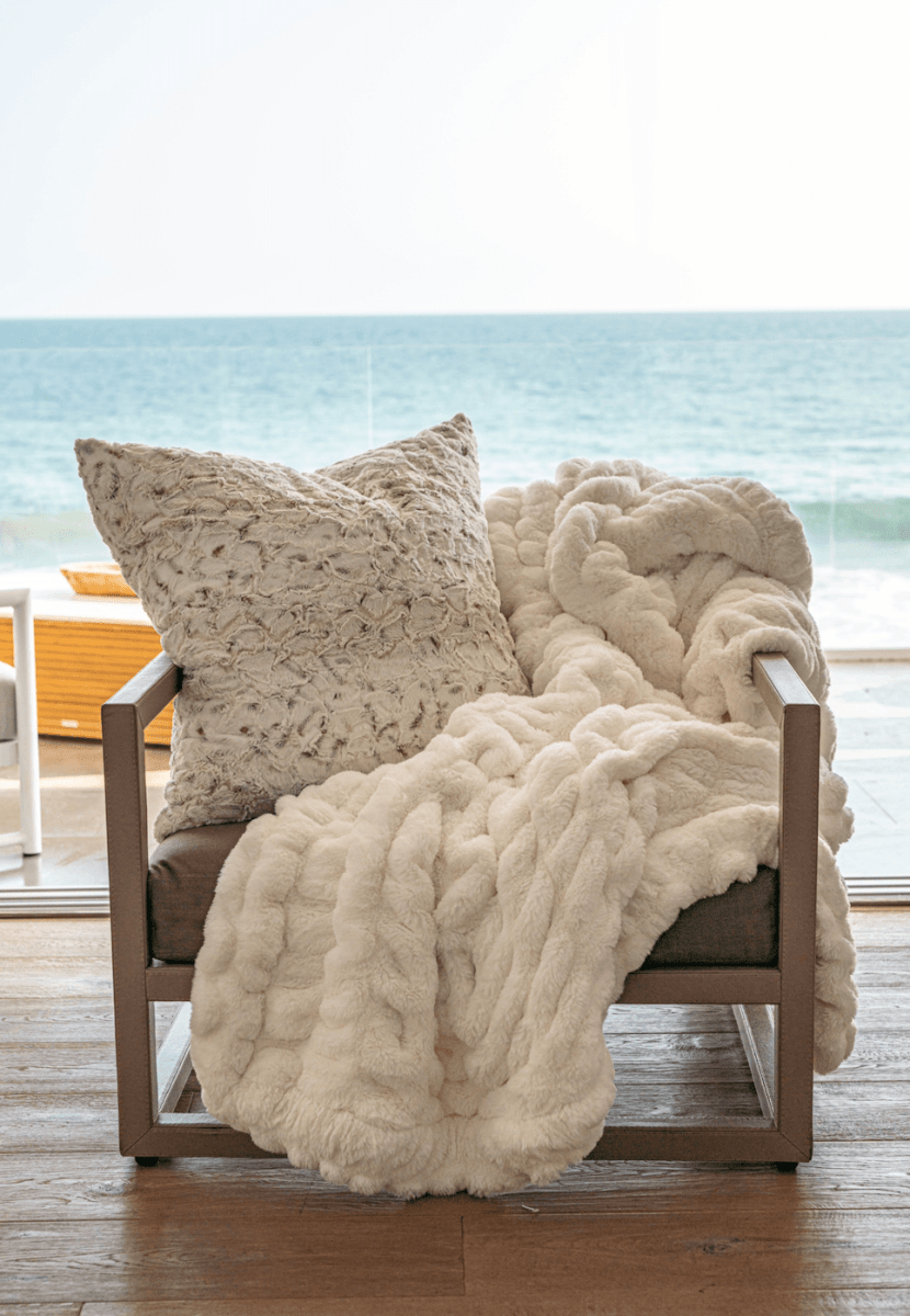 Ivory White Cloud Throw ultra soft luxury faux fur weighted blanket draped in living room beach house