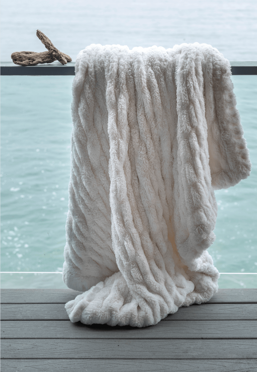 Ivory White Cloud Throw ultra soft luxury faux fur weighted blanket draped in beach house