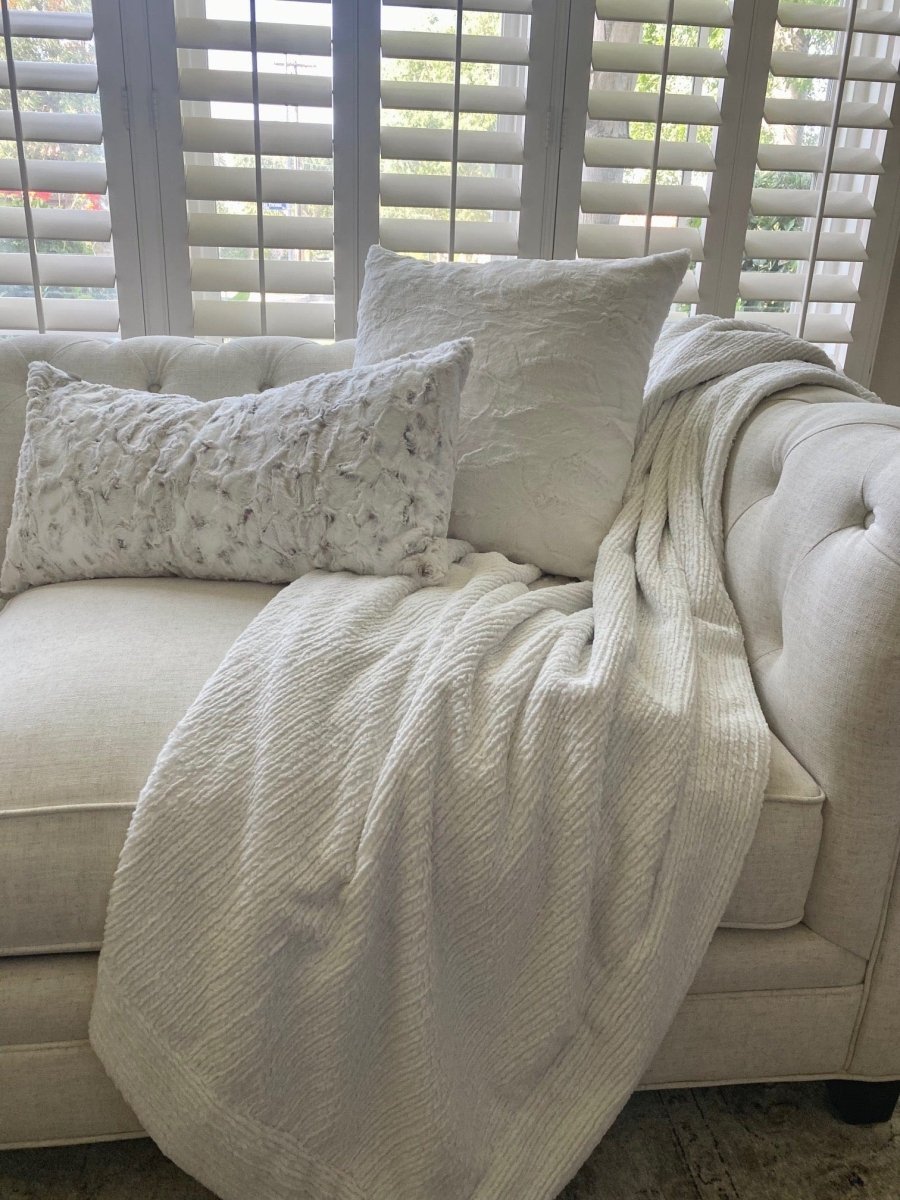 Ivory Weave White Cream Throw in ultra soft high quality woven material draped over couch.