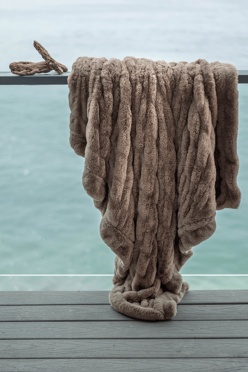 Mocha Brown Cloud Throw ultra soft luxury faux fur weighted blanket draped in beach house