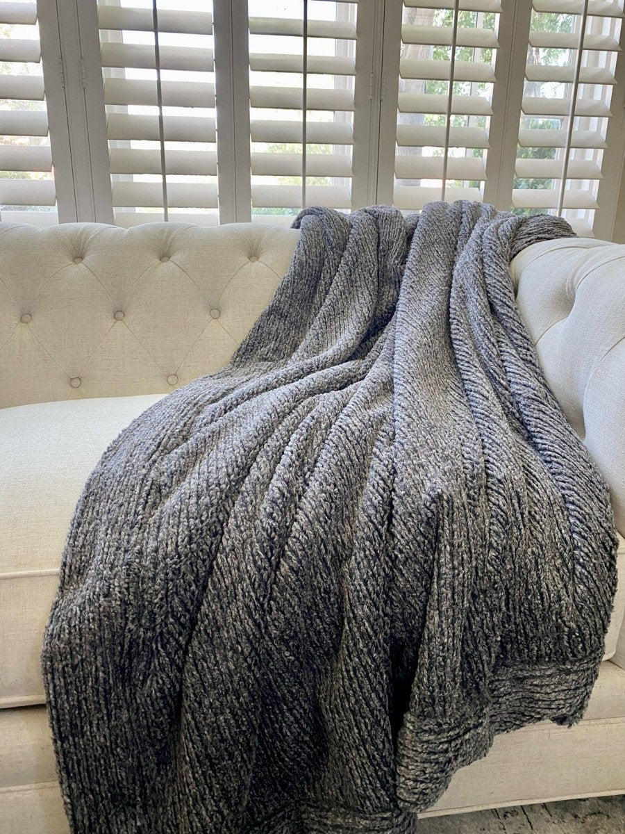 Onyx Black Weave Throw soft woven blanket draped over living room couch in home