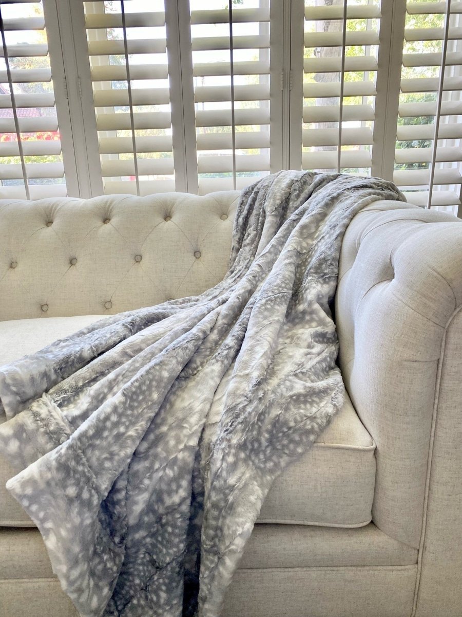 Silver Blue Gray Fawn Throw soft faux fur blanket draped living room couch home