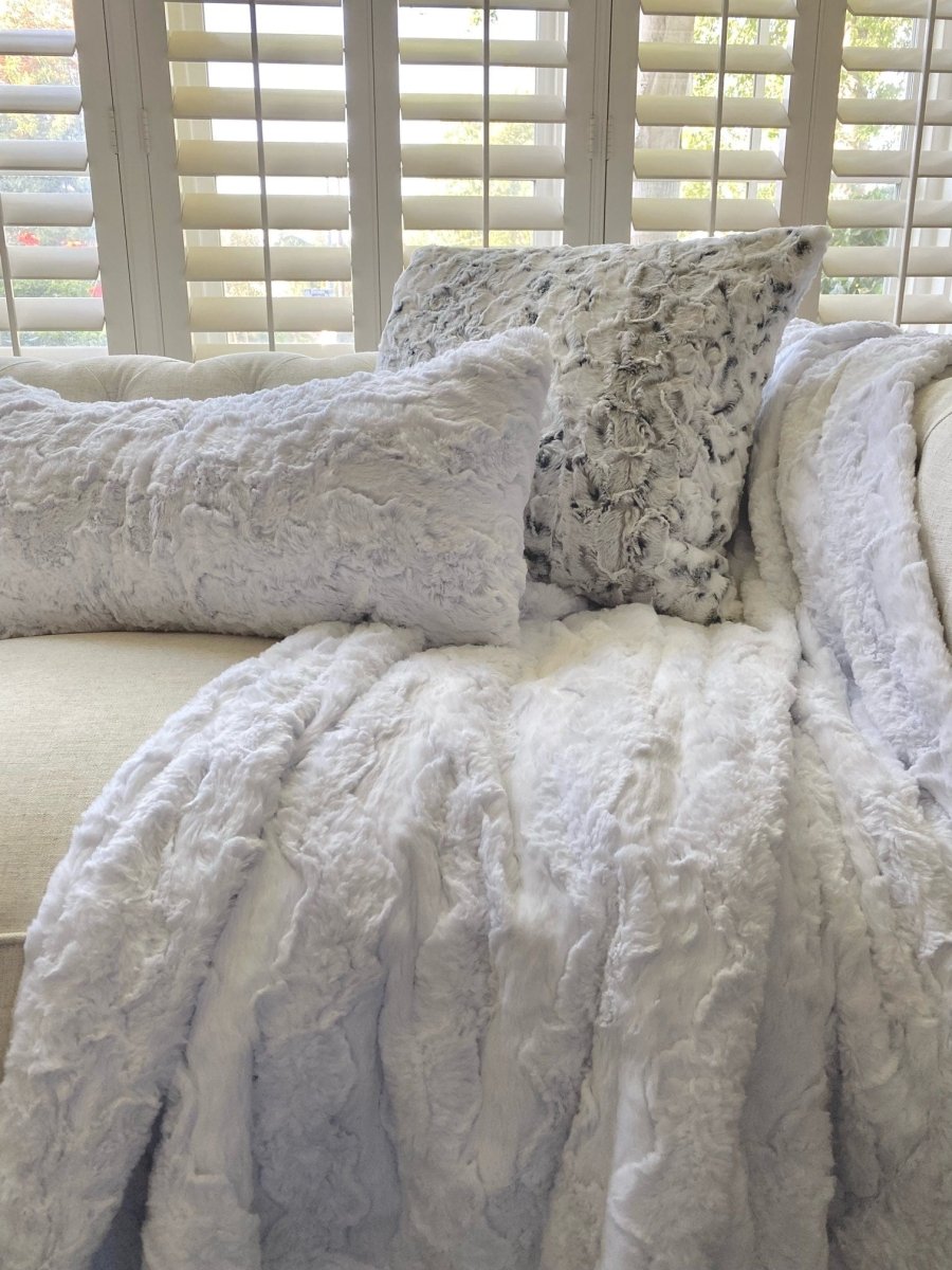 White Bella Throw soft faux fur blanket draped on living room couch home